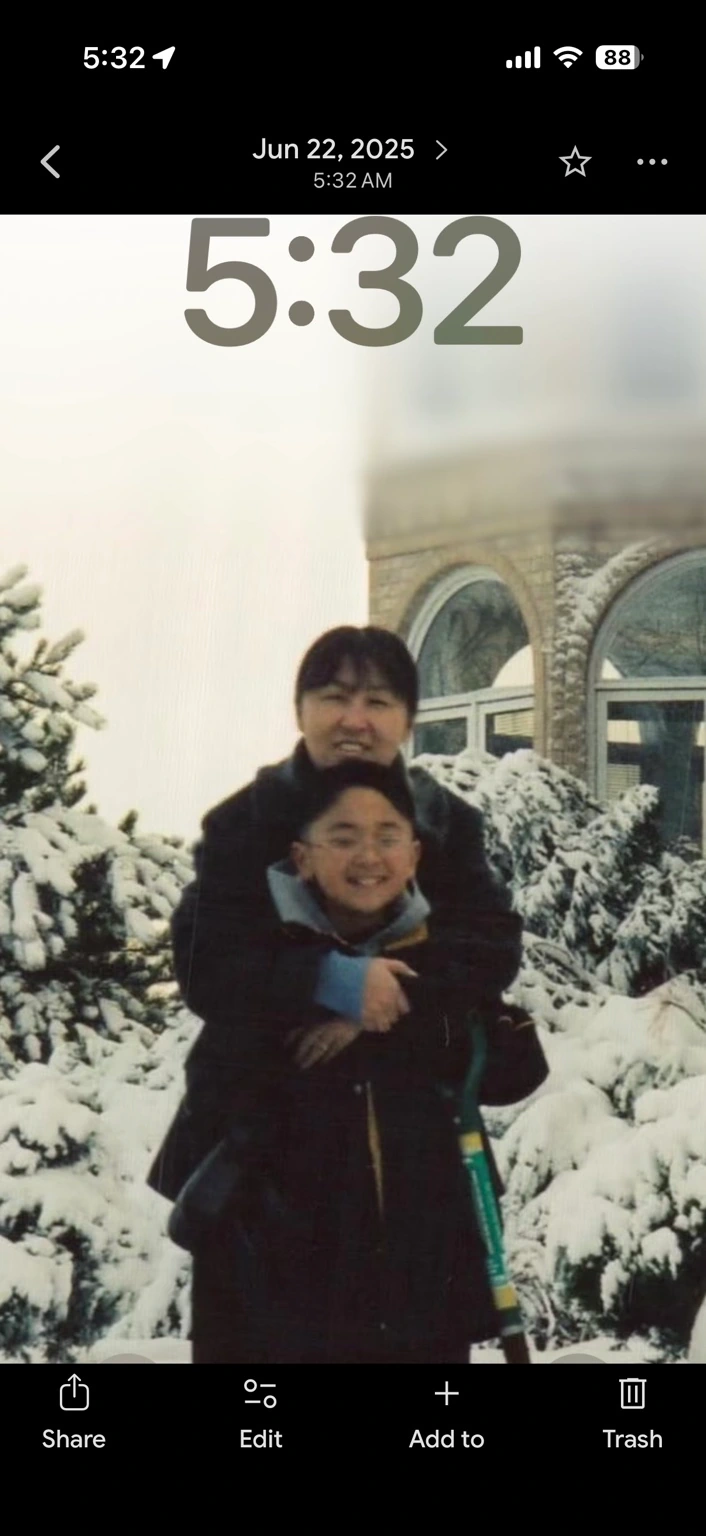 Brian as a child with his mother in the snow